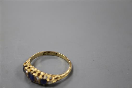 A George V 18ct gold, three stone sapphire and six stone diamond set half hoop ring,